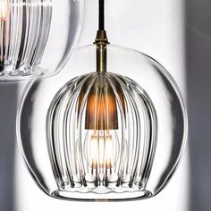 two clear glass pendant lights hanging from the ceiling