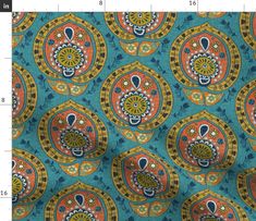 a blue and orange fabric with an ornate design on the front, in different colors