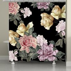 a black shower curtain with pink and yellow roses on it