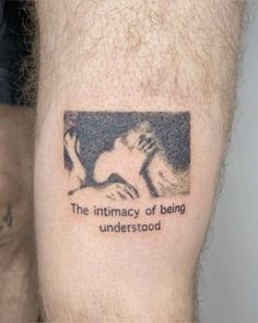 a man with a tattoo on his leg that says, the intimacy of being understood