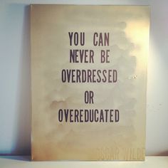 a sign that says you can never be overdressed or overeducated