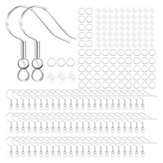 an assortment of earrings and piercings on a white background