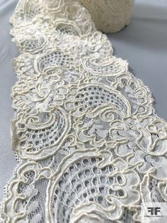 an image of a white lace on a table cloth that has been sewned