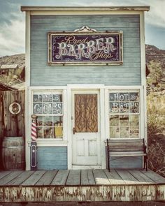 a painting of a barber shop on the side of a building