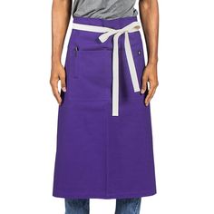 a man wearing a purple apron and grey shirt with his hands on his hips, standing in front of a white background