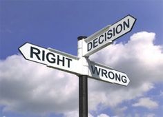 two street signs pointing in opposite directions against a blue sky and white cloud filled sky