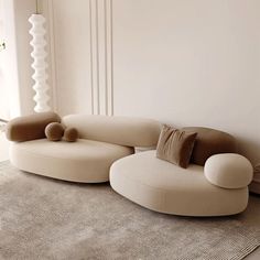 a living room filled with furniture and a rug on top of a carpeted floor