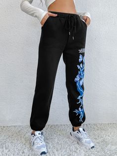 Turn heads on the track or in the gym with these joggers that have a high-waist design, a drawstring closure and stretchy, comfortable fabric. Size Guide: Alina is 5’7” tall, and has a 31.1” bust, 22.8” waist, & 34.6” hips. She is wearing a S / US 4 / AU 8. This pants is true to size. Material: 65% polyester / 35% cotton Feature: Relax fit, Graphic print, Twin hip pockets Care Instructions: Machine wash / Cold hand wash Athleisure Streetwear Joggers With Elastic Waistband, Athleisure Joggers With Elastic Waistband For Streetwear, Black Drawstring Sportswear Pants, Athleisure Sweatpants With Drawstring For Streetwear, Trendy Drawstring Sweatpants For Jogging, Trendy Black Sweatpants For Sports, Sporty Streetwear Joggers With Drawstring, Sporty Joggers With Drawstring For Streetwear, Streetwear Athleisure Joggers With Drawstring