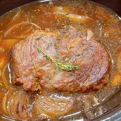 a beef stew in a slow cooker with potatoes and carrots on the side