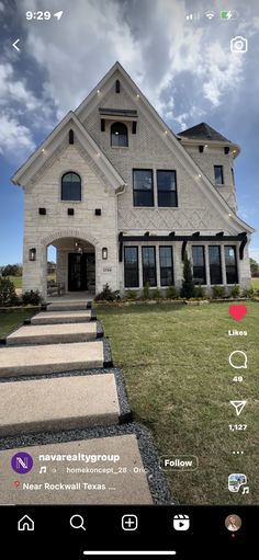 a house with stairs leading up to the front door, and windows on the side