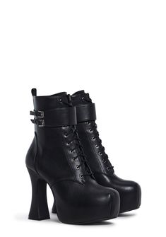 These shoes have a vegan leather construction with a paneled design, a block heel, a lace-up front closure, and a double buckle ankle strap closure. Black Platform Boots With Lace-up Fastening For Fall, Lace-up Chunky Platform Heels In Faux Leather, Punk Style High Heel Lace-up Boots In Faux Leather, High Ankle Platform Boots With Buckle In Faux Leather, Leather Lace-up Boots With Chunky Block Heel, Edgy Lace-up Boots In Polyurethane, Edgy Heeled Boots With Buckle In Faux Leather, Gothic Leather Heels With Chunky Platform, Gothic Chunky Platform Leather Heels