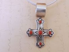 Visually stunning piece! Vintage find 925 sterling silver Navajo cross necklace with red coral stones.  Pendant is in great vintage condition and backside is marked sterling and artist hallmark R Coriz for Raymond Coriz of the Santo Domingo - Pueblo Kewa tribe Pendant hangs on new 18 inch sterling silver 2mm wide foxtail chain with lobster clasp as shown in last picture.  Pendant may be purchased without chain for $50 less.  Measurement,  Pendent measures 1.7 inch (44mm) by 1.08 inch (27mm) wide. Pendant is light weight, about 5.9 grams without chain. Cross Necklace Vintage, Picture Pendant, Coral Stone, Jewelry Women, Necklace Vintage, Red Coral, Vintage Necklace, Vintage Finds, Halloween Shopping