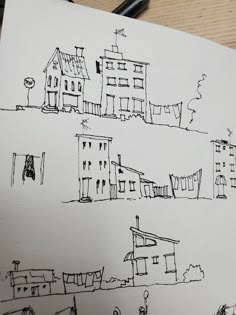 a drawing of some buildings on a piece of paper