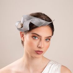 This sculptural headpiece is made of premium sinamay hand shaped into swirls. The headpiece is secured to a comfortable silk-covered double wire headband. The metallic silver fascinator adds an elegant, feminine touch to the attire of bridesmaids and wedding guests, effortlessly complementing a wide range of bridal styles, whether you prefer a sophisticated updo or a more relaxed, flowing hairstyle. This fascinator is handmade from lightweight millinery sinamay, ensuring comfort for all-day wear Silver Headband For Evening, Silver Fascinator For Kentucky Derby Races, Elegant Silver Hair Accessories For Evening, Silver Headpieces For Kentucky Derby Party, Silver Fitted Fascinator For Evening, Elegant Silver Fascinator For Wedding, Elegant Silver Wedding Fascinator, Silver Headpiece For Party At Royal Ascot, Silver Headpieces For Party At Royal Ascot