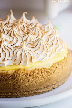 a cake with white frosting sitting on top of a plate