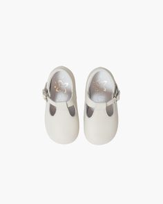 Indulge your little one in luxury with our Baby Boy T-Bar Shoes in Cream. Made with 100% soft leather and a flexible rubber sole, these elegant shoes offer a comfortable fit with buckle fastening and a padded insole. Perfect for any occasion, add a touch of sophistication to your child's outfit. Bar Shoes, Shoes Cream, Hand Smocked Dress, Baby Boy Shirts, Girls Special Occasion Dresses, T Bar Shoes, Old Shoes, Cream Shoes, Our Baby