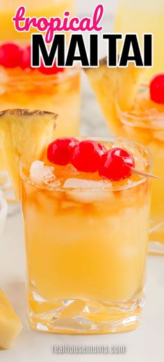 two glasses filled with pineapple and red cherries