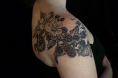 a woman's shoulder with flowers and butterflies on it