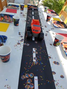 a long table with cars and confetti on it