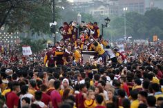 a large group of people are gathered in the street