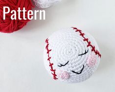 a crocheted baseball with eyes closed next to a ball of yarn and the words pattern on it