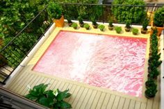 an above ground pool surrounded by greenery