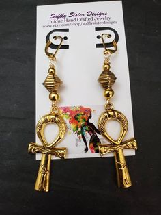 "Beautiful handmade earrings made with high quality gold plated metal Ankh symbol, and nickel free gold plated leverback earwires. Lightweight and easy to wear, these earrings are 3\" long. Please come back and visit to check for more unique new designs and styles For more styles visit my Etsy shop:www.etsy.com/shop/SoftlySisterDesigns" Ankh-shaped Metal Earrings For Gift, Ankh Shaped Metal Earrings For Gift, Gold Ankh Metal Jewelry, Gold Ankh Shaped Metal Jewelry, Adjustable Gold Plug Earrings With Ear Wire, Symbolic Metal Dangle Earrings, Nickel Free Ankh Earrings For Gift, Nickel-free Ankh Earrings As Gift, Ankh-shaped Earrings For Pierced Ears As Gift