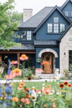 a house that has flowers in front of it