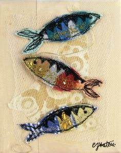 three colorful fish on a white background with gold and blue accents in the shape of circles