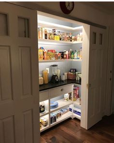 an open pantry door with food on the shelves