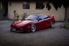 a red sports car parked in front of a house