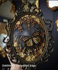 there is a butterfly on the mirror with flowers and butterflies all over it's face