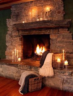 a fireplace with candles and blankets on it