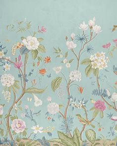 a wall with flowers and birds painted on the side of it in pastel blue