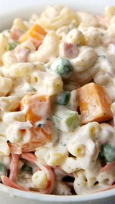 a bowl filled with macaroni salad on top of a table