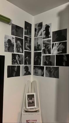 the wall is covered with black and white photos