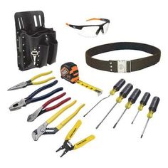 tools are laid out on a white background with black belt and safety glasses in the foreground