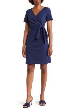 A woven crepe dress features a side-tie closure that accentuates your waistline for a flattering fit. Back keyhole with button-and-loop closure V-neck Short sleeves 96% polyester, 4% spandex Machine wash, tumble dry Made in the USA Elegant Workwear Dress With Tie Fastening, Chic Formal Dress With Knot Detail, Blue Fitted Dress With Tie Fastening, Fitted Blue Dress With Tie Fastening, Chic Fitted Dress With Side Ties, Knee-length Tie Waist Mini Dress For Work, Knee-length Mini Dress With Tie Waist For Work, Chic Dresses With Tie Sleeves For Workwear, Chic Dresses With Knot Detail For Work