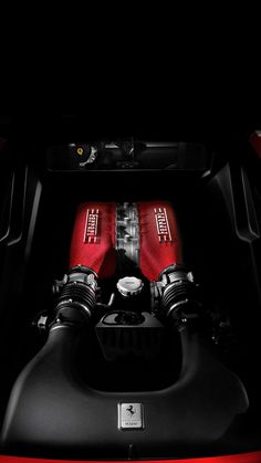 the engine compartment of a red sports car