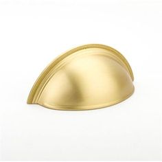 a gold colored object on a white background