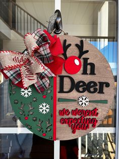 a wooden sign hanging on the side of a glass door that says koh deer