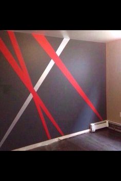 an empty room with red and white lines painted on the wall next to a radiator