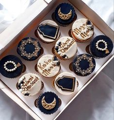 twelve decorated cupcakes in a box with congratulations written on the front and side