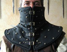 a man wearing a black leather collar with spikes on it