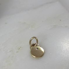 This adorable charm is entirely hand-crafted from recycled 14k gold, which I melt down and form into this petite, organic little pendant. It is then hand-stamped with two sweet leaves and is finished with a genuine flush set diamond. Available with either a shiny gold or satin finish. Includes an open jumpring for hanging. It will be your favorite new spring necklace! *This listing is for one Diamond Petal Charm only. Chain not included and shown with other charms for layering options. :: Solid 14k Gold Pendant Charm Necklace With Vintage Charm, 14k Gold Vintage Charm Pendant Necklace, Everyday Round Minimalist Charms, Minimalist Everyday Round Charms, Dainty Yellow Gold Charms Tarnish Resistant, Yellow Gold Moon Charm Necklace With Round Pendant, Dainty Yellow Gold Tarnish-resistant Charms, Minimalist Everyday Pendant Charms, 14k Gold Charms For Everyday Wear