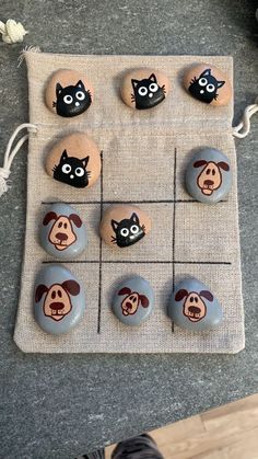 rocks with cartoon faces are arranged on a mat