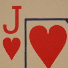 the back side of a playing card with two hearts and one letter j on it