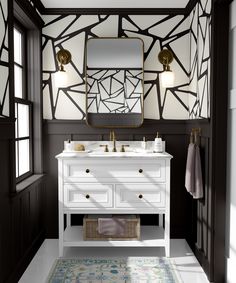 a white sink sitting under a mirror in a bathroom next to a rug on the floor