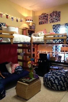 a room with bunk beds, couches and other furniture