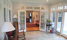 a living room filled with furniture and lots of windows